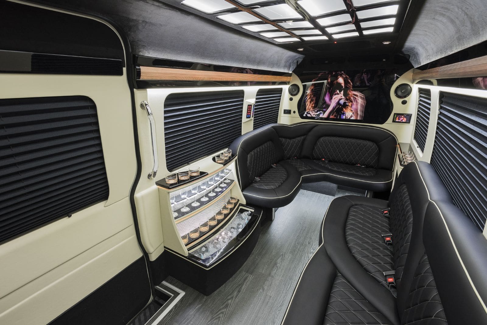 Custom interior, black leather seats, drink cooler, tvs, and more in the Mercedes Sprinter Limo.